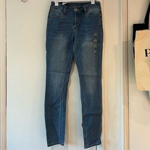 Blue skinny jeans with a low rise and a straight leg.